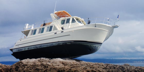 Boat left high and dry on the rocks
