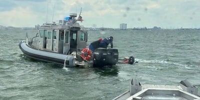 Chareslton harbor rescue in proccess with boat pulling people out of the water