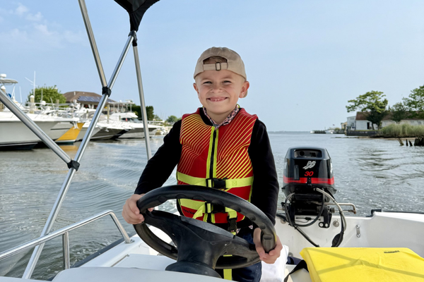 Life is Better Teaching my 6 year old grandson how to operate a boat on my 25 yr old 13ft Boston Whaler Sport.
